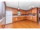 Bright kitchen with wood cabinets, hardwood floors and vintage appliances at 411 W Killiegrey St, Lillington, NC 27546