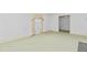 Bright, carpeted living room with a window and doorway to another room at 411 W Killiegrey St, Lillington, NC 27546