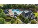 Aerial view of the community pool and clubhouse surrounded by manicured landscaping and trees at 4125 Enfield Ridge Dr, Cary, NC 27519