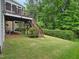 Scenic backyard features a wooden deck with stairs and a well-maintained lawn at 4125 Enfield Ridge Dr, Cary, NC 27519