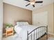 Bedroom with a ceiling fan, neutral walls, and a wrought iron bed at 4125 Enfield Ridge Dr, Cary, NC 27519