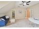 Bonus room with a blue sofa and a storage closet offering ample room for organization at 4125 Enfield Ridge Dr, Cary, NC 27519