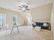 Large bonus room with a blue sofa, a round table, and two windows providing natural light at 4125 Enfield Ridge Dr, Cary, NC 27519