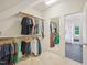 Walk-in closet featuring a mirror, closet organizer, and rod with hanging clothes at 4125 Enfield Ridge Dr, Cary, NC 27519