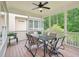 Covered porch with a ceiling fan, a table with six chairs, and screened-in views of the forest at 4125 Enfield Ridge Dr, Cary, NC 27519