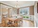 Elegant dining room with a large window, hardwood floors, and stylish lighting at 4125 Enfield Ridge Dr, Cary, NC 27519