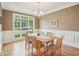 Traditional dining room with a large window, hardwood floors, and stylish chairs at 4125 Enfield Ridge Dr, Cary, NC 27519