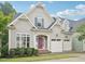 Charming gray home featuring manicured landscaping and a welcoming red front door at 4125 Enfield Ridge Dr, Cary, NC 27519