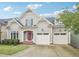 Charming gray home with a red front door and a two-car garage at 4125 Enfield Ridge Dr, Cary, NC 27519