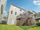 Exterior view of the home's deck, stairs, screened-in porch, and lawn at 4125 Enfield Ridge Dr, Cary, NC 27519