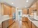 Well-lit kitchen features wooden cabinets, stainless steel appliances, gas range, and hardwood floors at 4125 Enfield Ridge Dr, Cary, NC 27519