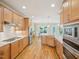 Well-lit kitchen features wooden cabinets, stainless steel appliances, gas range, and hardwood floors at 4125 Enfield Ridge Dr, Cary, NC 27519