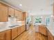 Well-lit kitchen features wooden cabinets, stainless steel appliances, gas range, and hardwood floors at 4125 Enfield Ridge Dr, Cary, NC 27519