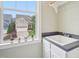 Bright laundry room with sink, white cabinets, and a window with a view of the home's exterior at 4125 Enfield Ridge Dr, Cary, NC 27519