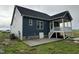 Exterior view of new home with porch, concrete patio, and light and dark contrasting siding at 4167 Old Stage N Rd # 4, Angier, NC 27501