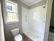 Bathroom with a window and white tiled walk in shower at 4167 Old Stage N Rd # 4, Angier, NC 27501