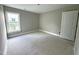 Cozy bedroom bathed in natural light with a large window and a door on the side at 4167 Old Stage N Rd # 4, Angier, NC 27501