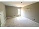 Empty bedroom with a window, neutral walls, and unfinished floors at 4167 Old Stage N Rd # 4, Angier, NC 27501