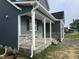 Exterior view of home featuring stone accents, a covered front porch, and complementary colored siding at 4167 Old Stage N Rd # 4, Angier, NC 27501