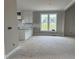 Kitchen featuring white cabinets, granite countertops, and view to large windows at 4167 Old Stage N Rd # 4, Angier, NC 27501