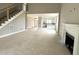Living room with fireplace, view of stairs, kitchen, and front door at 4167 Old Stage N Rd # 4, Angier, NC 27501