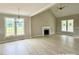 Open living room featuring wood floors, fireplace, vaulted ceilings, a chandelier, and abundant natural light at 4167 Old Stage N Rd # 4, Angier, NC 27501