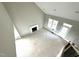 Open-concept living room with vaulted ceilings, fireplace, and natural light from large windows at 4167 Old Stage N Rd # 4, Angier, NC 27501