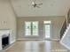 Bright and airy living room with wood floors, fireplace, ceiling fan and abundant natural light from multiple windows at 4167 Old Stage N Rd # 4, Angier, NC 27501