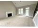 Bright living room with fireplace, tall ceilings, large windows and door, and stairs at 4167 Old Stage N Rd # 4, Angier, NC 27501