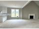 Open floor plan with living area, fireplace, and kitchen featuring white cabinets and granite countertops at 4167 Old Stage N Rd # 4, Angier, NC 27501