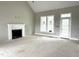 Open living room with a fireplace, large windows, and neutral paint at 4167 Old Stage N Rd # 4, Angier, NC 27501