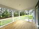 Covered porch with wooden floors and white railings overlooking a large grassy yard at 4167 Old Stage N Rd # 4, Angier, NC 27501