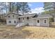 A nice view of the back of the home, including the siding, windows, well kept lawn, and back entrance at 4307 Pope Rd, Durham, NC 27707