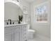 This bathroom features a gray vanity, modern fixtures, and natural light at 4307 Pope Rd, Durham, NC 27707