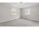 This bedroom boasts neutral paint, carpet flooring, and natural light from the double-hung windows at 4307 Pope Rd, Durham, NC 27707