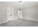 This bedroom offers carpeted floors, a closet, neutral paint, and an interior door at 4307 Pope Rd, Durham, NC 27707