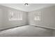 This bedroom features neutral paint, carpet flooring, and natural light from the double-hung windows at 4307 Pope Rd, Durham, NC 27707