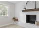Living room showcasing the fireplace with a shiplap wall and natural light at 4307 Pope Rd, Durham, NC 27707
