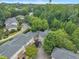 Overhead aerial showcases the community nestled amongst mature trees, close to nearby city at 4802 Glenmist Ct, Raleigh, NC 27612