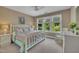 Bright bedroom with a white wooden bed frame and view of the trees outside at 4802 Glenmist Ct, Raleigh, NC 27612