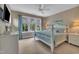 Bright bedroom with a four-poster bed, light-blue bedding, and view of the landscaped backyard at 4802 Glenmist Ct, Raleigh, NC 27612