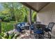 Relaxing covered patio with outdoor seating, a fire pit, and well-maintained landscaping at 4802 Glenmist Ct, Raleigh, NC 27612