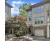 Beautiful townhome featuring stone accents, a garage, manicured landscaping, and an inviting entrance at 4802 Glenmist Ct, Raleigh, NC 27612