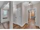 Hallway with wood floors leading to the kitchen with a wood accent wall at 4802 Glenmist Ct, Raleigh, NC 27612