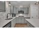 Modern kitchen features grey cabinets, granite countertops, stainless steel appliances, and subway tile backsplash at 4802 Glenmist Ct, Raleigh, NC 27612