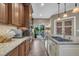 Elegant kitchen with a large island, modern appliances, and a view of the backyard through sliding glass doors at 4802 Glenmist Ct, Raleigh, NC 27612