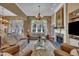 Spacious living room with stone fireplace, lots of comfortable seating and large windows at 4802 Glenmist Ct, Raleigh, NC 27612