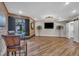 Finished basement space with wood floors, bar seating, and access to patio at 4802 Glenmist Ct, Raleigh, NC 27612