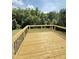 Back deck with wood flooring and black railings featuring treeline views at 50 Moonraker Dr, Spring Hope, NC 27882