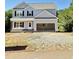 New two-story home featuring light gray siding, black shutters, and an attached two-car garage at 50 Moonraker Dr, Spring Hope, NC 27882